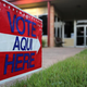 A bilingual sign stands outside a polling center at public library ahead of local elections on April 28, 2013, in Austin, Texas.
John Moore/Getty Images